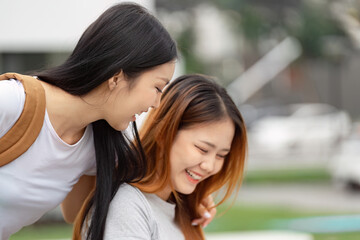 Diverse university students laughing and enjoying friendship outdoors.