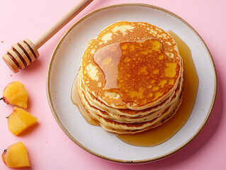 Food image: perfectly golden pancakes with a layer of honey.