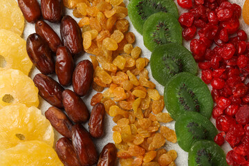 Different dried fruits on light table, flat lay