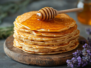 Food image: a plate of warm pancakes with honey topping.