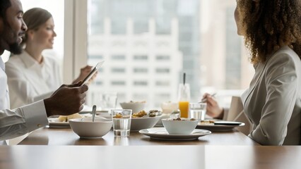 Business Colleagues Enjoying Breakfast Meeting In Modern Office