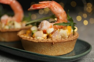 Tartlets with delicious filling on table, closeup. Bokeh effect
