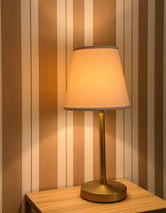 Close-up of a table lamp with striped wallpaper, mindfulness theme. with white shades