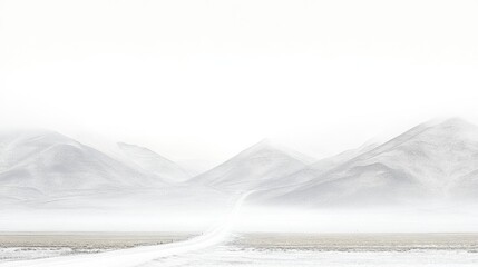 Serene Landscape of Misty Mountains with a Narrow Road Leading into the Horizon
