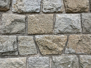 uneven stone wall texture background in brown and grey color