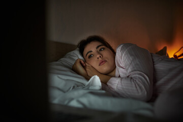 Struggling with shadows of sadness in a quiet, dimly lit bedroom