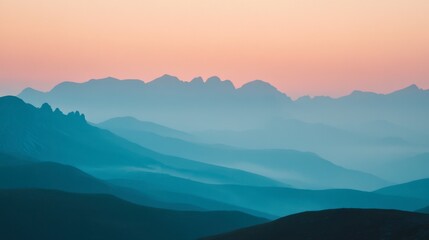 Fototapeta premium A peaceful sunset over the Italian Alps, with soft orange and pink hues illuminating the jagged mountain peaks.