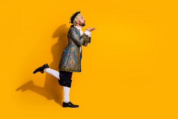 Young nobleman in ornate costume with a vibrant yellow background evoking historical elegance