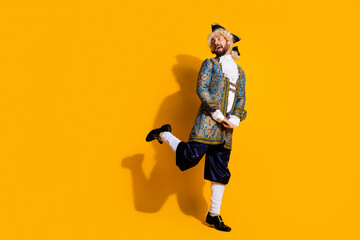 Young Man in Historic Nobleman Costume Posing Against Vibrant Yellow Background
