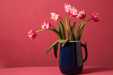Beautiful pink terry tulips in a metal vintage blue jug