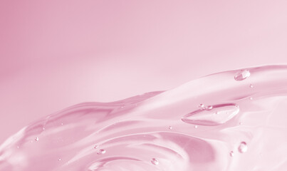 Abstract soft pink liquid with flowing texture and bubbles on a soft pastel background. Elegant and...