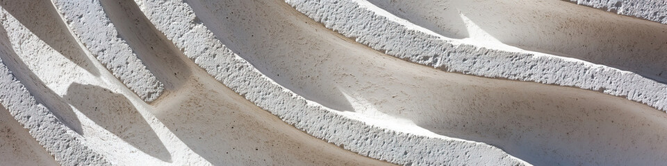 White Concrete Surface with Layered, Curved Texture