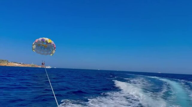 Thrilling Ride: Parasailing Behind a Ferry
