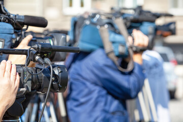 Professional television cameras filming live media event, news or press conference with copy space