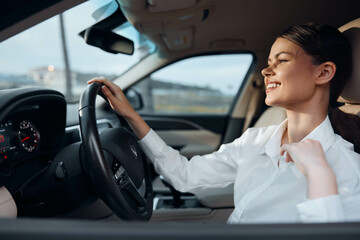 Driver, car, woman, steering wheel, looking at camera a woman sits in the driver's seat of a car with her hands on the steering wheel, gazing directly at the camera, conveying readiness and confidence