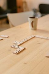 Vertical high angle shot of domino tiles on top of wooden table