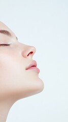 Profile of beautiful young woman with closed eyes enjoying her breath after successful rhinoplasty surgery, concept of cosmetology and beauty treatment