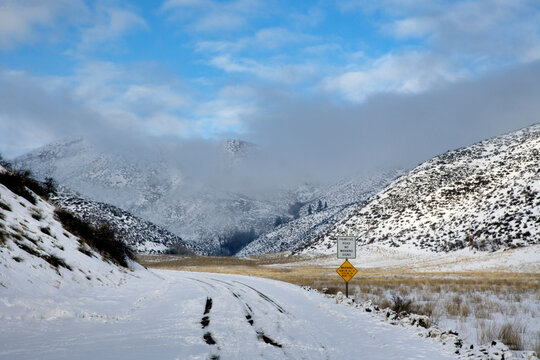 Tire tracks on a snowy back road up a track in the Methow Valley in Washington State.