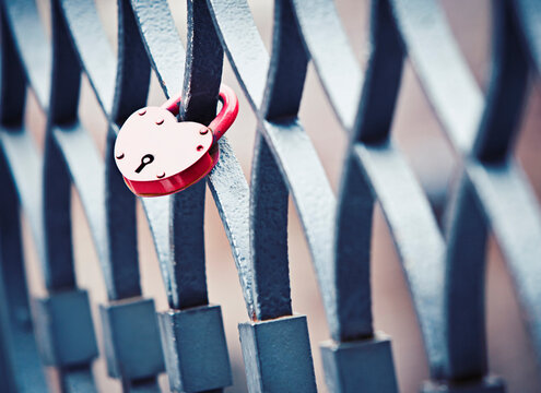 A heart shaped lock left by two lovers on a bridge railing in the city of love, Venice
