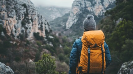 Faceless alpinist climbing up on cliff in Spain