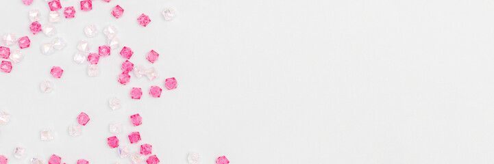 Banner with acrylic beads scattered on a blue background.