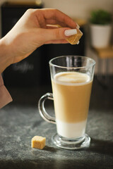  A cup of latte with sugar. Warm, comforting, and coffee break concept.