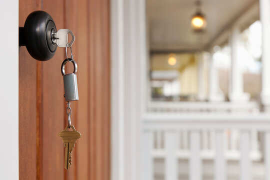 Close up of key in front door lock.