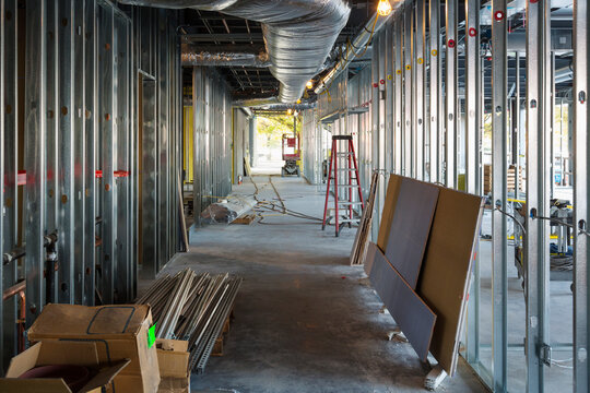 A commercial building under construction with roof ducts and light gauge steel framing.