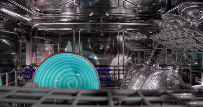 Open dishwasher with clean dishes. Housekeeping concept.