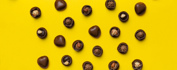 Different kinds of chocolates on colored table close-up. Top View and Flat Lay