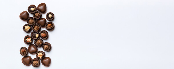 Different kinds of chocolates on colored table close-up. Top View and Flat Lay with copy space