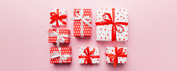 Valentine day composition Background: red gift box with bow and heart. Christmas present. View from...