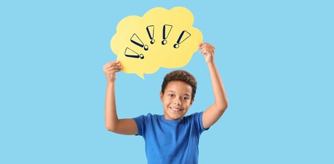 Little African-American boy holding speech bubble with exclamation marks on blue background