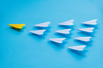Leadership concept, yellow paper airplane origami leading other white airplanes. Leadership skills...