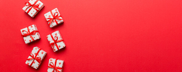 Valentine day composition: red gift box with bow and heart. Christmas present. View from above....