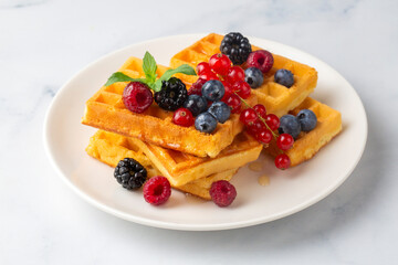 Delicious fresh baked belgian waffles with berries and fruit
