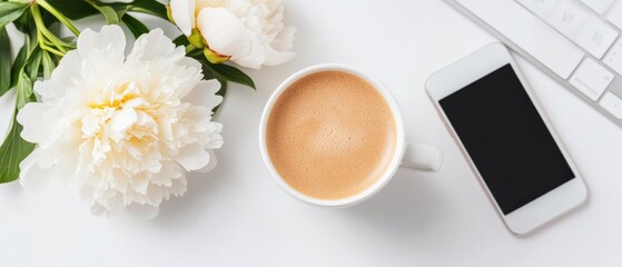 feminine workspace with coffee, flowers, and phone
