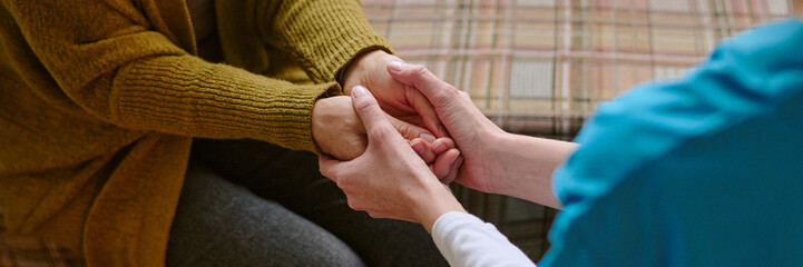 Website banner with unrecognizable nurse holding hands of senior resident of nursing home