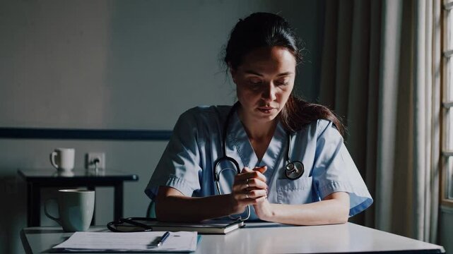 In a dimly lit hospital break room, a nurse sits at a small table, visibly stressed. Her hair is slightly disheveled, and she wears scrubs with a name badge clipped to her pocket.