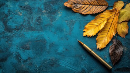Pen and leaves on blue surface with daily affirmations and copy space for realistic photography