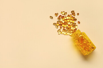 Overturned bottle with fish oil capsules on color background
