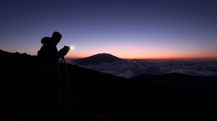 Silhouetted Mountain Explorer Against Twilight Sky Creating Moody Adventure Photography with Dramatic Landscape Scenery