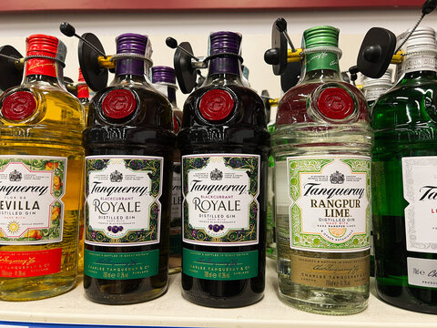 Kyiv, Ukraine - February 04, 2025: Various Tanqueray gin bottles displayed on a store shelf with security caps