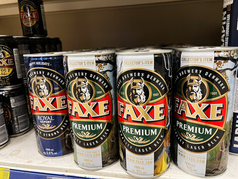 Kyiv, Ukraine - February 04, 2025: Assorted Faxe beer cans displayed on a supermarket shelf in vibrant colors