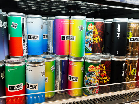 Kyiv, Ukraine - February 04, 2025: Colorful beverage cans in a store display tilled with vibrant designs.