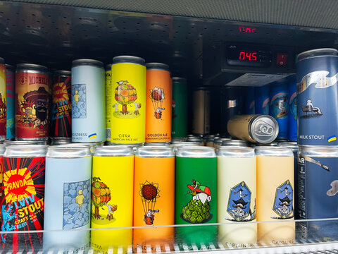 Kyiv, Ukraine - February 04, 2025: Colorful beer cans in a refrigerated display with diverse handcrafted designs