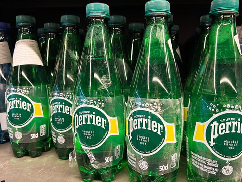 Kyiv, Ukraine - February 04, 2025: Bottles of Perrier Sparkling Water Displayed on a Store Shelf