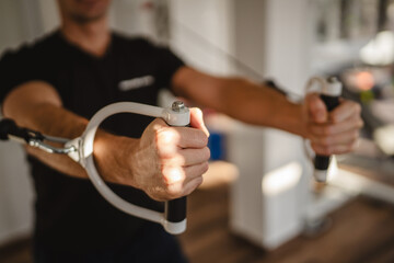 Focused workout with resistance cables in fitness center