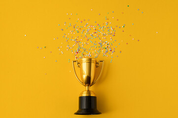 Bright sparkling background with winner cup. Flat lay, space for text.