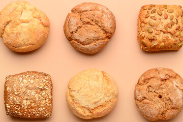 Different delicious buns on beige background